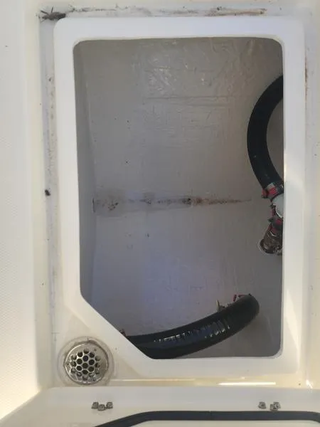 Slide: The Image of Pathfinder 2400 Open 2025 boat compartment with drainage and hoses. - 3