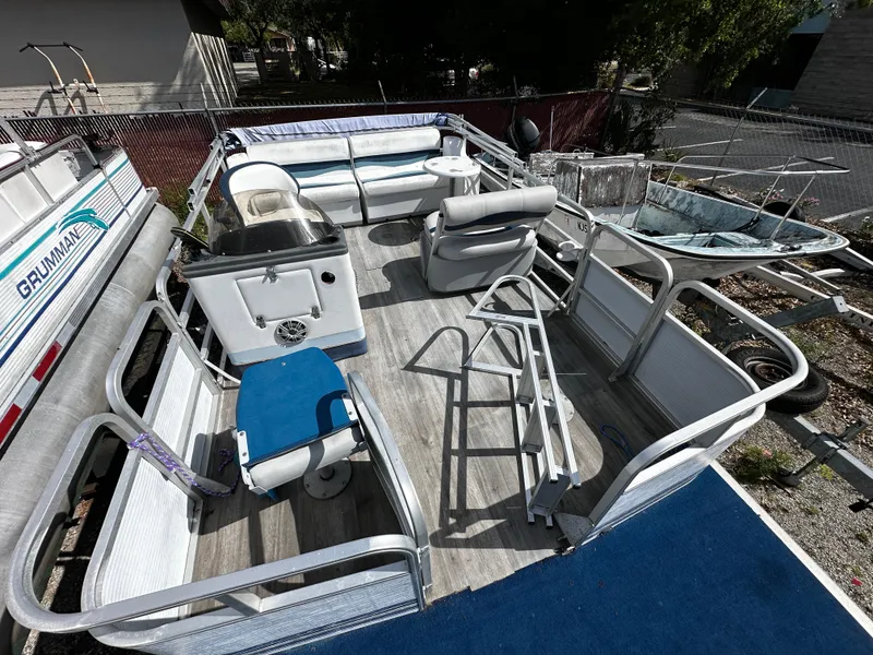 Slide: The Image of 1994 Sylvan Adventure pontoon boat with seating and open deck layout. - 14