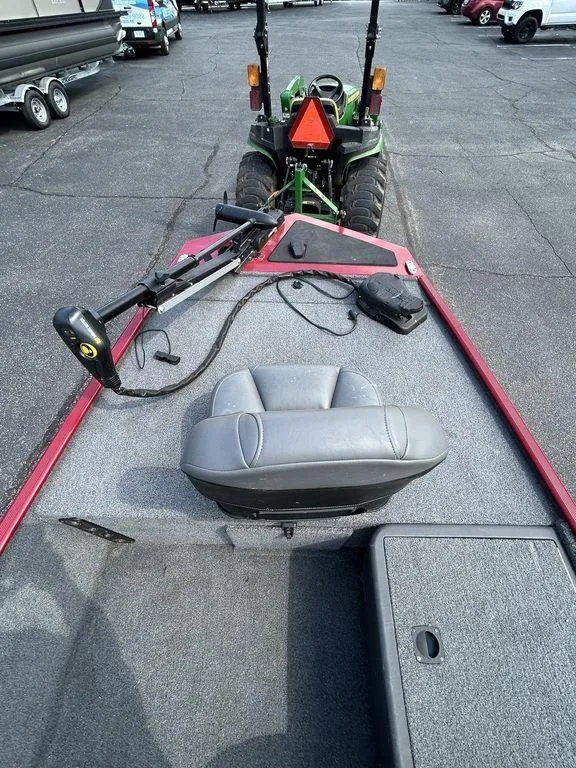 Slide: The Image of 2023 Tracker BASS TRACKER® Classic XL boat with seating and equipment, parked on pavement. - 6