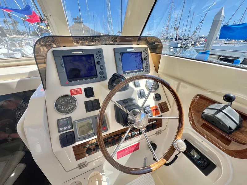 Slide: The Image of 2006 Mainship Pilot 30-II Sedan helm with navigation instruments and steering wheel. - 12