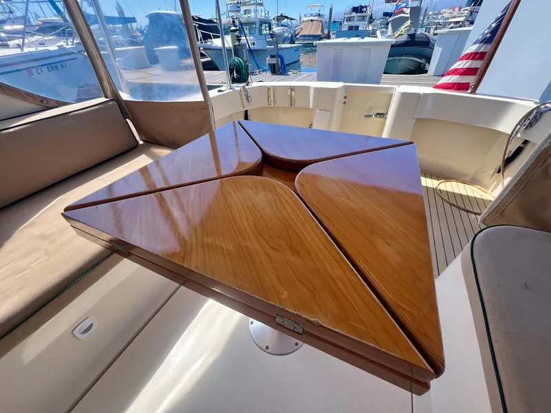 Slide: The Image of 2006 Mainship Pilot 30-II Sedan interior with elegant wooden table and seating. - 13