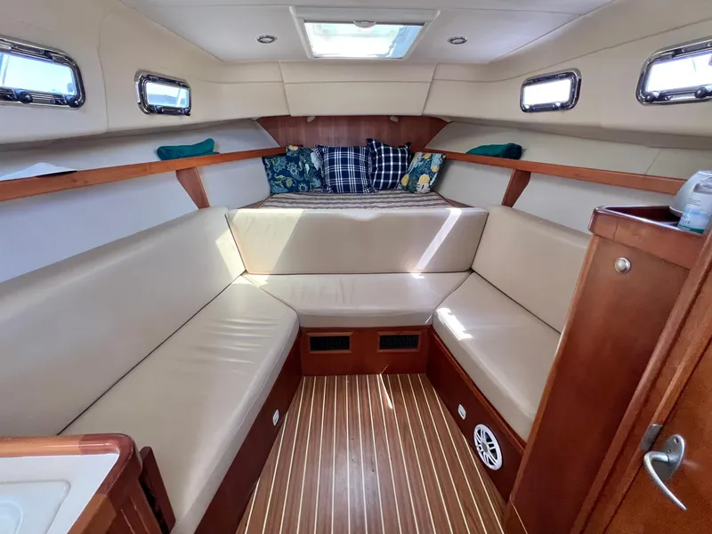 Slide: The Image of 2006 Mainship Pilot 30-II Sedan interior with beige seating and wood accents. - 20
