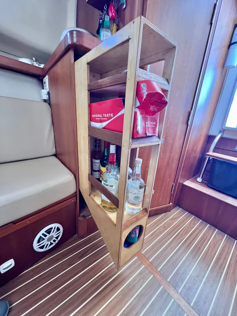 Slide: The Image of 2006 Mainship Pilot 30-II Sedan interior with wooden liquor shelf and seating. - 23