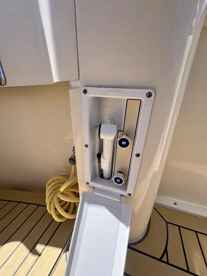 Slide: The Image of 2006 Mainship Pilot 30-II Sedan boat shower control with hose on deck. - 26