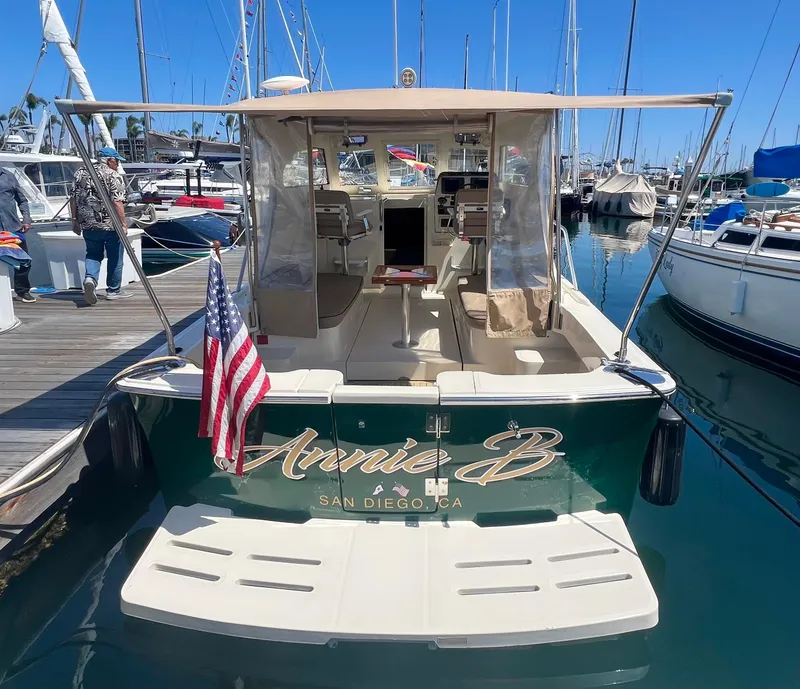 Slide: The Image of 2006 Mainship Pilot 30-II Sedan docked, displaying "Annie B" and American flag. - 28