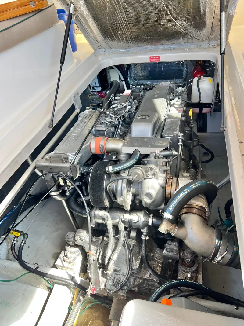 Slide: The Image of Engine compartment of a 2006 Mainship Pilot 30-II Sedan boat, showcasing detailed mechanical components. - 31