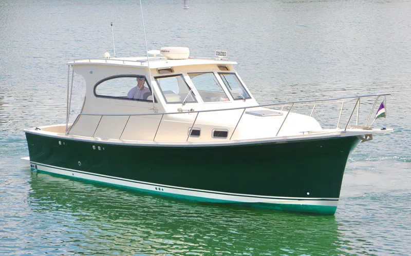 Slide: The Image of 2006 Mainship Pilot 30-II Sedan cruising on calm water. - 4