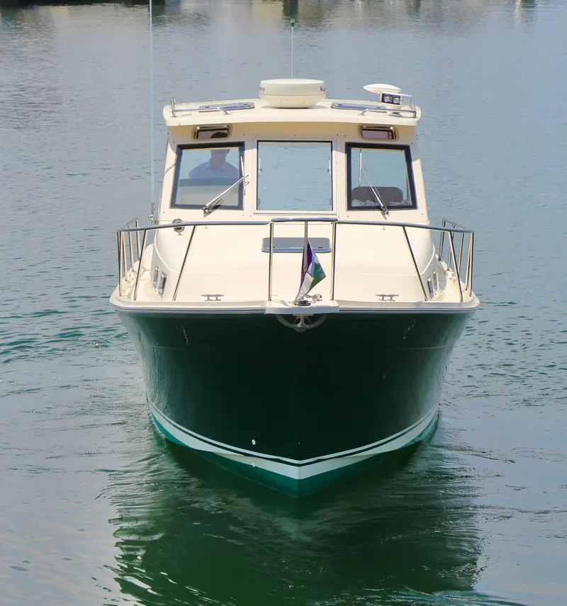 Slide: The Image of 2006 Mainship Pilot 30-II Sedan boat on calm water, front view. - 5