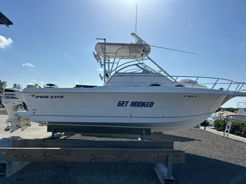 Slide: The Image of 1999 Pro-Line 2950 WALK boat on display, featuring "Get Hooked" text on the side. - 1