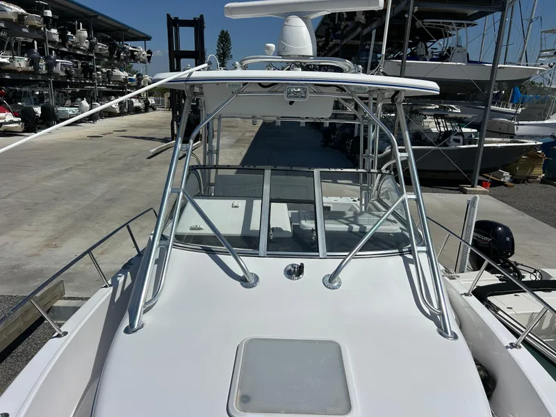 Slide: The Image of 1999 Pro-Line 2950 WALK boat with sleek design, docked at a marina. - 10