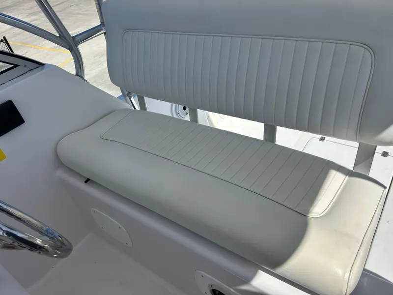 Slide: The Image of 1999 Pro-Line 2950 WALK boat interior with white cushioned seating. - 18