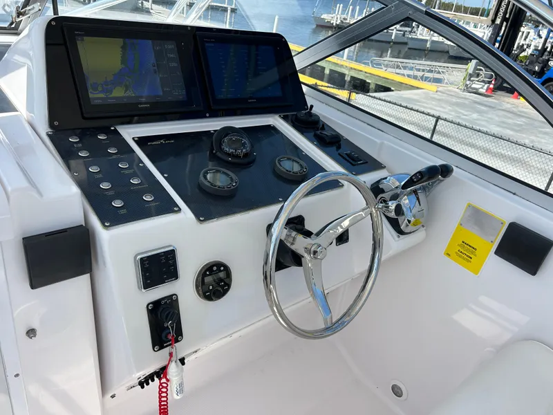 Slide: The Image of 1999 Pro-Line 2950 WALK boat dashboard with steering wheel and navigation controls. - 19