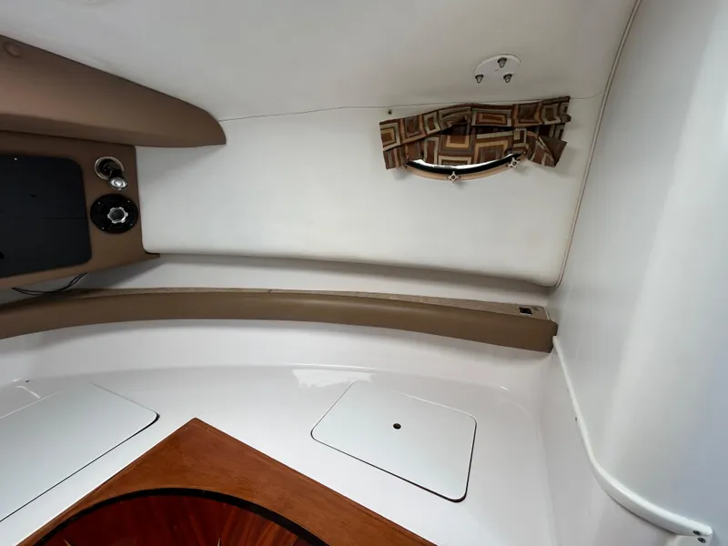 Slide: The Image of Interior cabin of a 1999 Pro-Line 2950 WALK boat, featuring storage compartments and a small window. - 25