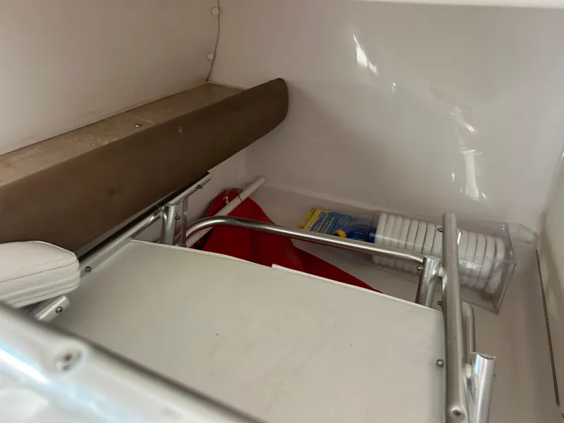 Slide: The Image of Interior storage of 1999 Pro-Line 2950 WALK boat with folded equipment and supplies. - 27