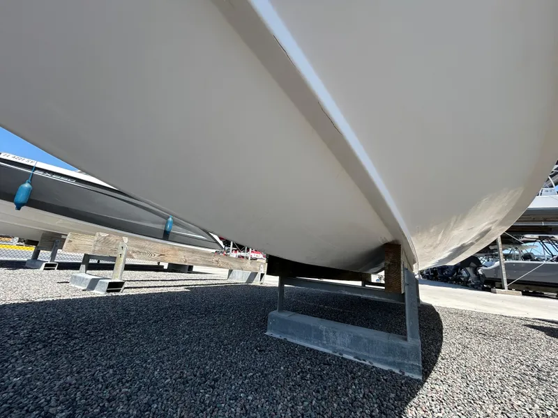 Slide: The Image of 1999 Pro-Line 2950 WALK boat hull on gravel, side view. - 4