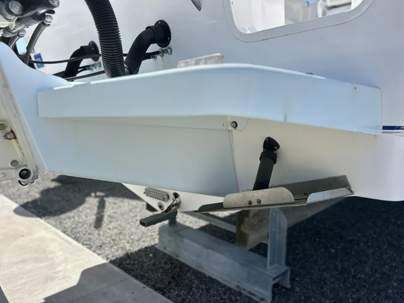 Slide: The Image of 1999 Pro-Line 2950 WALK boat detail showing trim tab and hull components. - 50