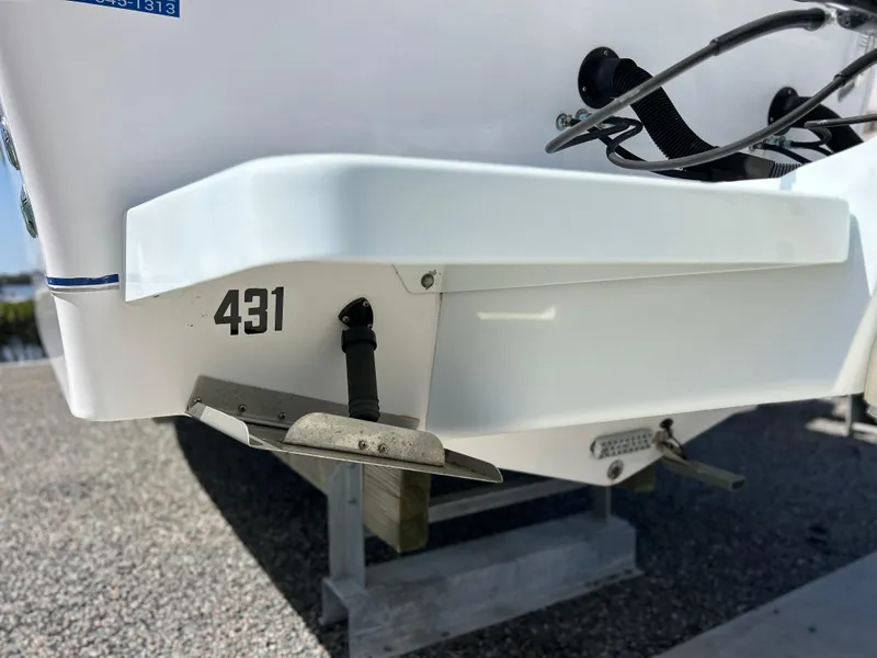 Slide: The Image of 1999 Pro-Line 2950 WALK boat stern with trim tabs and number 431. - 51