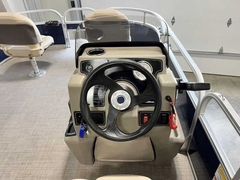 Slide: The Image of 2025 Sun Tracker Bass Buggy® 16 XL Select steering console with controls and seating. - 12