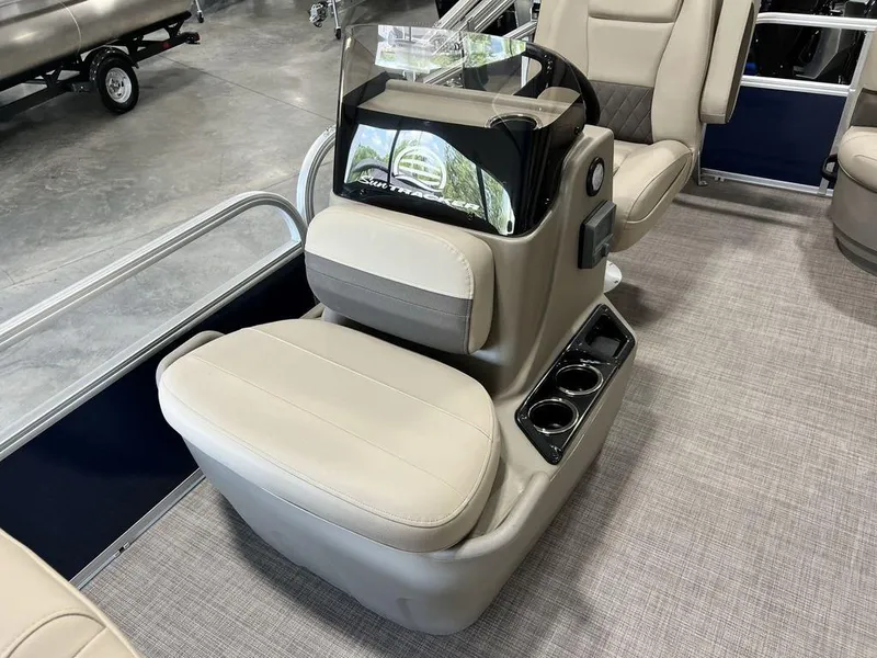 Slide: The Image of 2025 Sun Tracker Bass Buggy® 16 XL Select boat interior with beige seating and cup holders. - 6