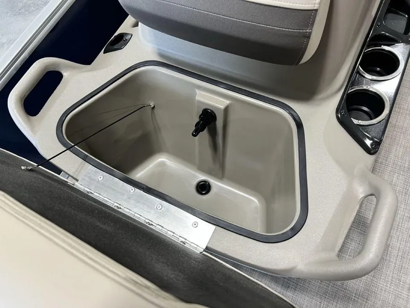 Slide: The Image of 2025 Sun Tracker Bass Buggy® 16 XL Select boat interior storage compartment with cup holders. - 7
