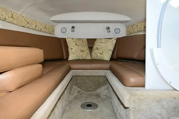 Slide: The Image of 2015 Crownline 236 SC cabin interior with brown seating and floral cushions. - 30