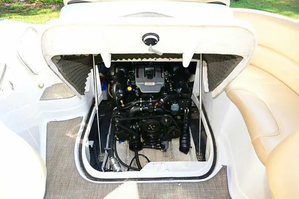 Slide: The Image of Engine compartment of a 2015 Crownline 236 SC boat, showcasing the motor and interior layout. - 25