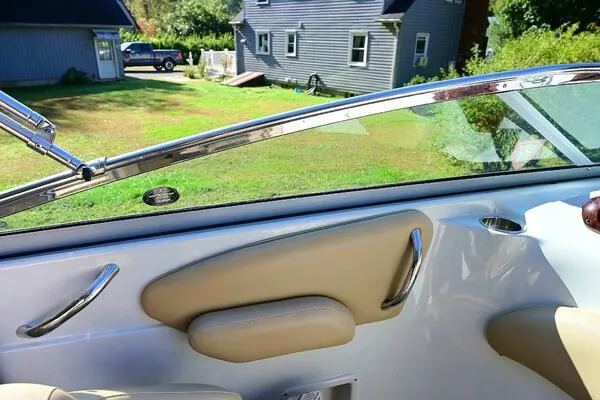 Slide: The Image of Interior view of 2015 Crownline 236 SC boat with beige upholstery and chrome accents. - 43