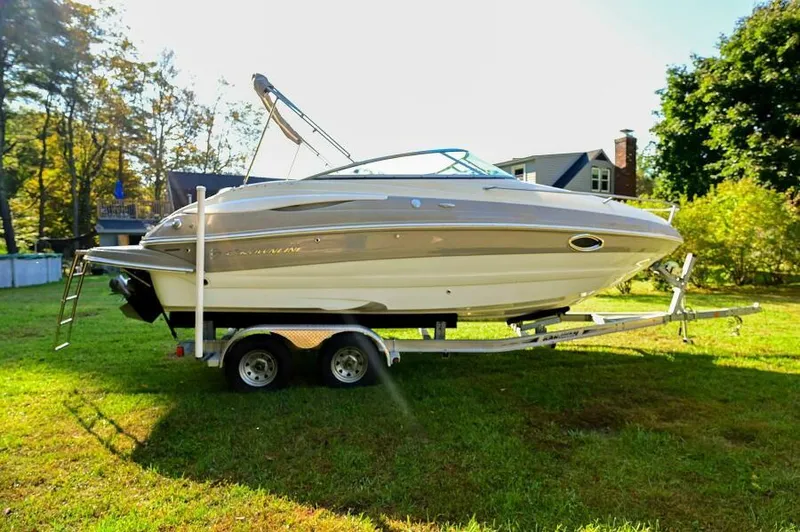 The Image of 2015 Crownline 236 SC boat on trailer in grassy yard. - 0