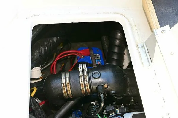 Slide: The Image of Engine compartment of a 2015 Crownline 236 SC boat, showing hoses and wiring. - 21