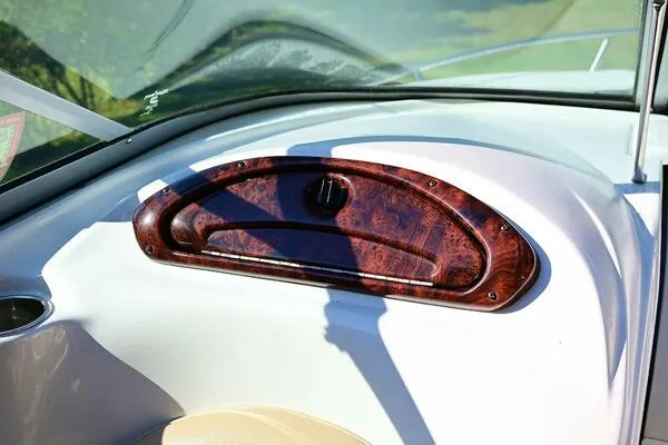 Slide: The Image of Dashboard of 2015 Crownline 236 SC boat with woodgrain finish and sleek design. - 37