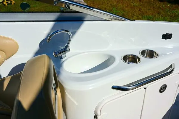 Slide: The Image of 2015 Crownline 236 SC boat interior with sink and cup holders. - 16