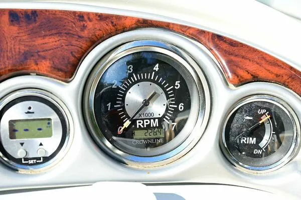 Slide: The Image of Dashboard of 2015 Crownline 236 SC boat showing RPM gauge and controls. - 34