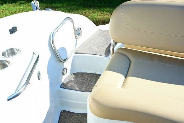Slide: The Image of 2015 Crownline 236 SC boat interior with beige seating and stainless steel accents. - 18