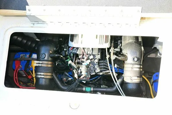 Slide: The Image of Engine compartment of a 2015 Crownline 236 SC boat, showcasing mechanical components. - 23