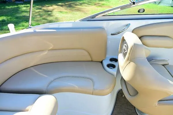 Slide: The Image of 2015 Crownline 236 SC boat interior with beige seating and cup holders. - 19