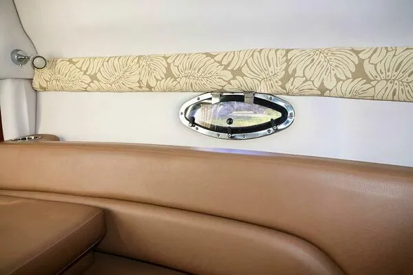 Slide: The Image of Interior of 2015 Crownline 236 SC boat with beige seating and floral trim. - 14