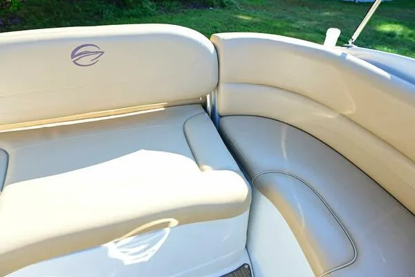 Slide: The Image of 2015 Crownline 236 SC boat interior with beige seating and logo. - 39