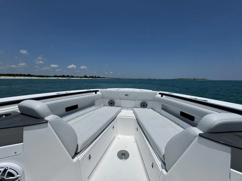 Slide: The Image of 2025 Crevalle 33 CSF boat interior with spacious seating, ocean view, and clear blue sky. - 11