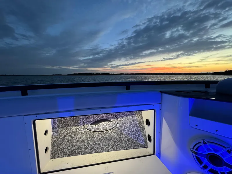 Slide: The Image of Crevalle 33 CSF 2025 boat interior with sunset view over the water. - 13