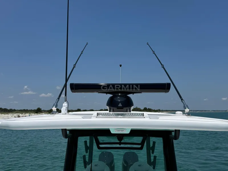Slide: The Image of 2025 Crevalle 33 CSF boat with Garmin radar, ocean backdrop, clear sky. - 17