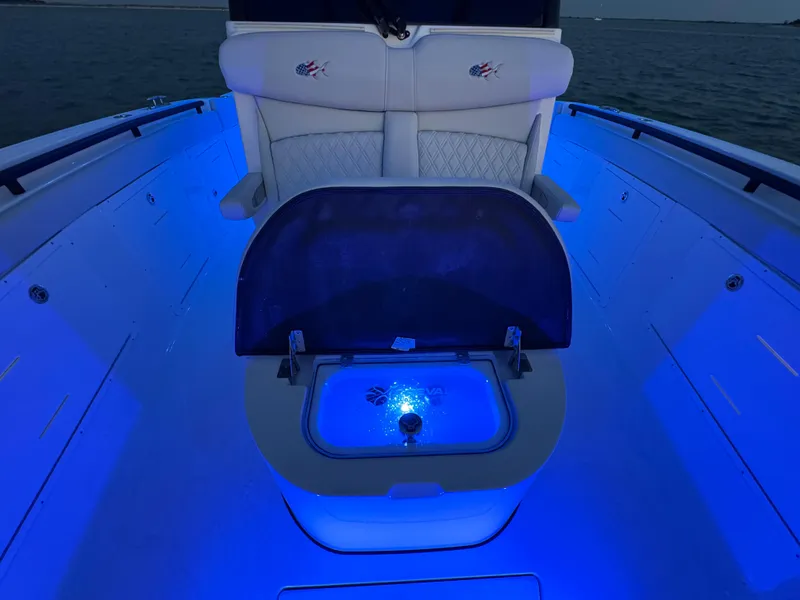 Slide: The Image of 2025 Crevalle 33 CSF boat interior with blue LED lighting and seating. - 19