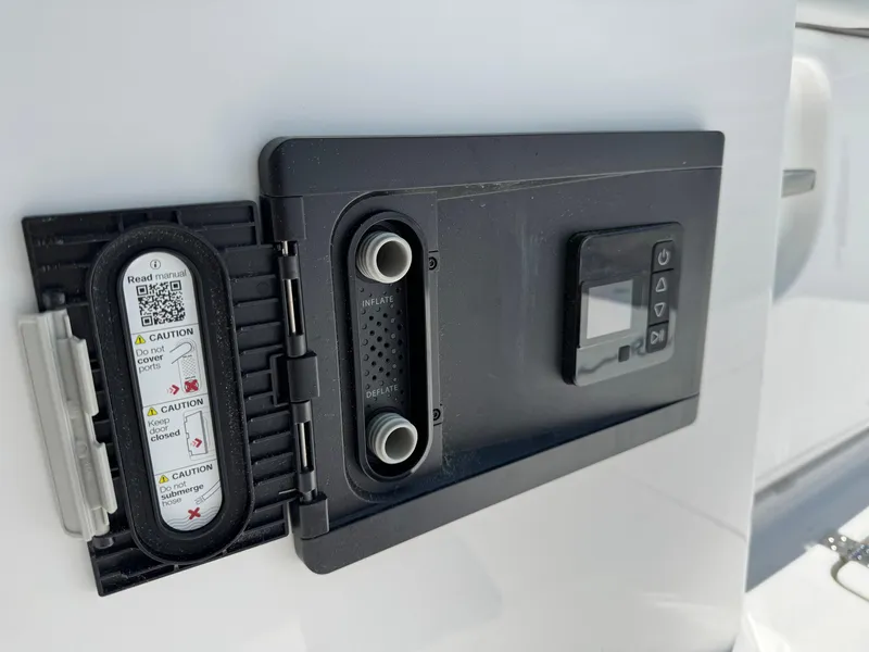 Slide: The Image of Control panel on 2025 Crevalle 33 CSF boat, featuring caution labels and digital display. - 33