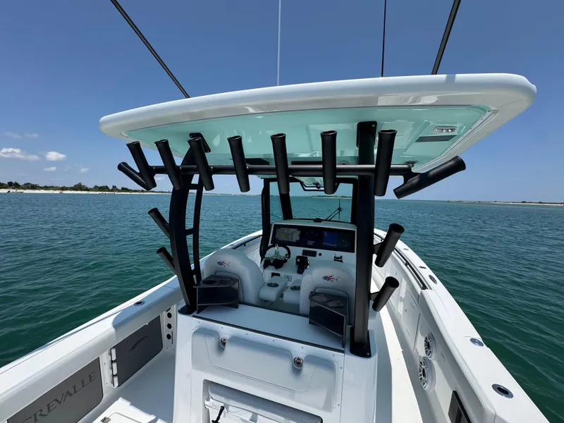 Slide: The Image of 2025 Crevalle 33 CSF boat on water, featuring center console and rod holders. - 35