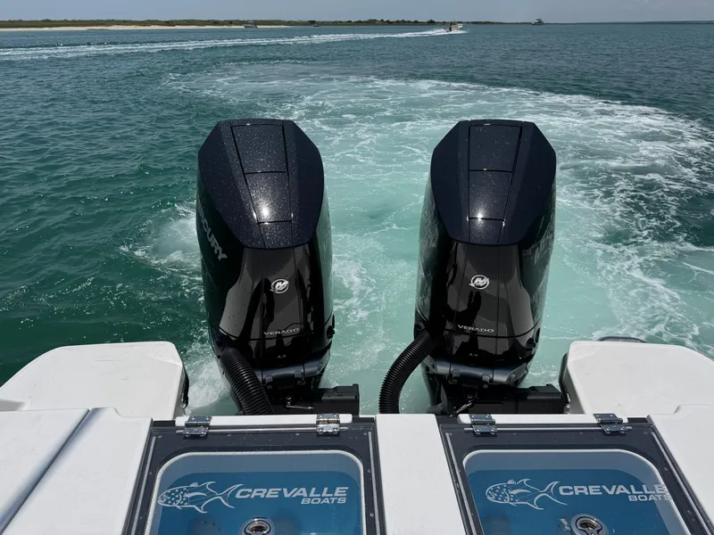 Slide: The Image of 2025 Crevalle 33 CSF boat with dual outboard engines cruising on open water. - 46