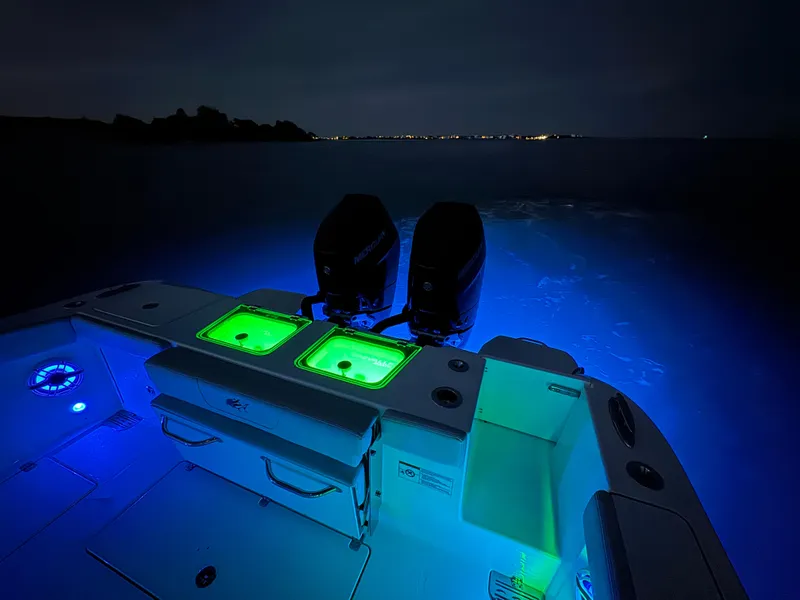 Slide: The Image of 2025 Crevalle 33 CSF boat with illuminated deck and dual engines at night. - 48