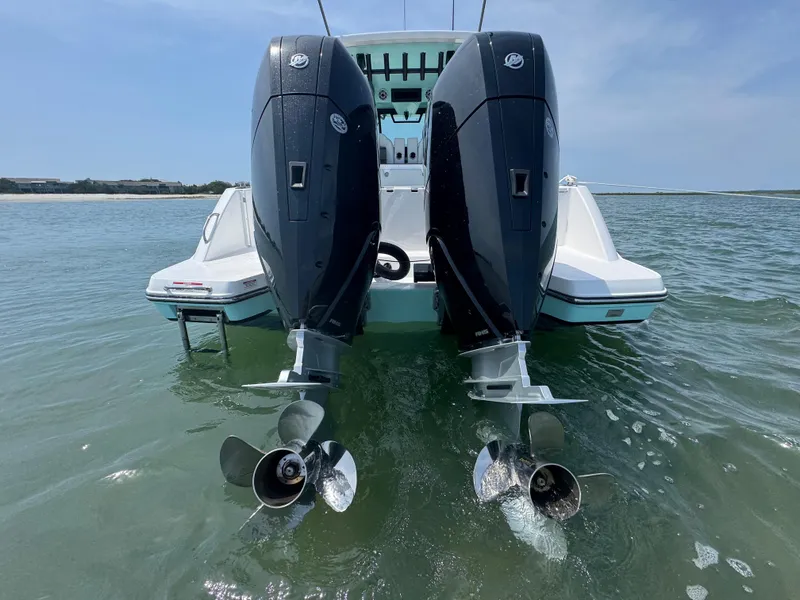 Slide: The Image of 2025 Crevalle 33 CSF boat with dual outboard engines in water. - 49