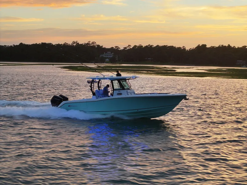 Slide: The Image of 2025 Crevalle 33 CSF boat cruising at sunset on calm waters. - 5