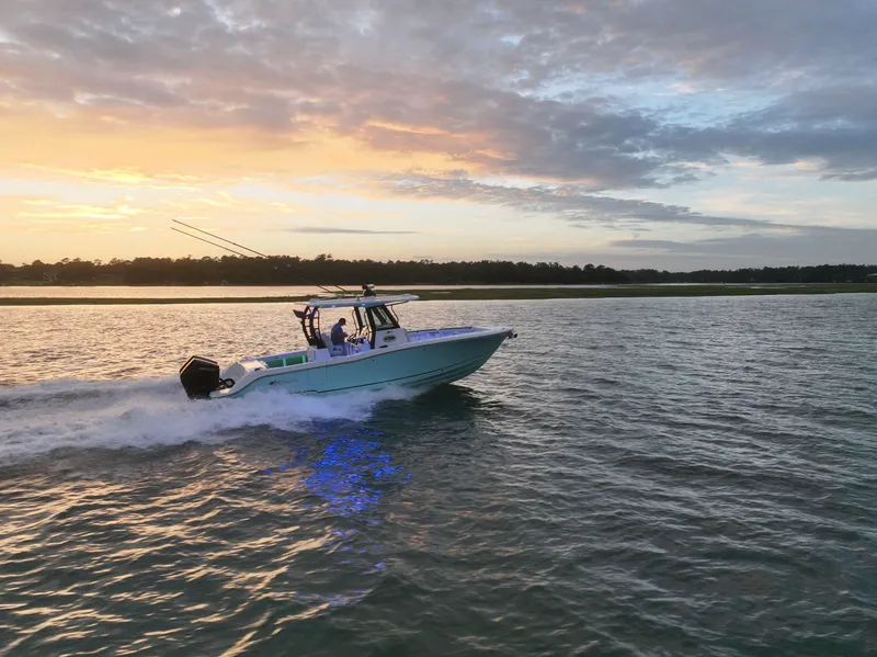 Slide: The Image of 2025 Crevalle 33 CSF boat cruising at sunset on calm waters. - 6