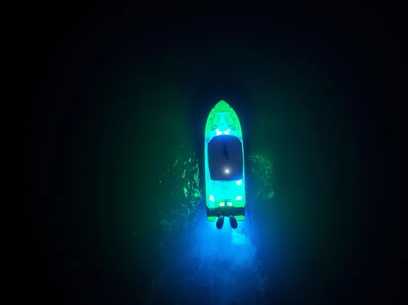 Slide: The Image of Aerial view of illuminated 2025 Crevalle 33 CSF boat on dark water. - 8