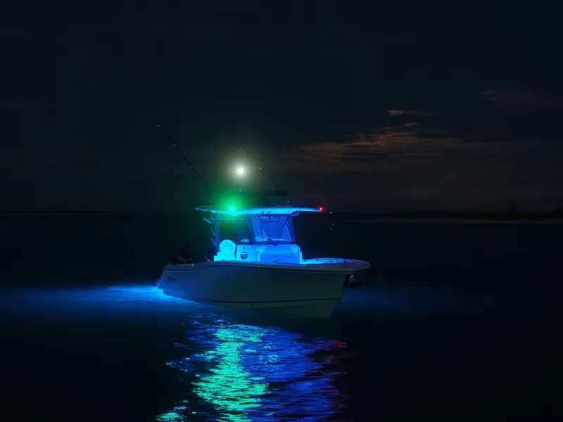 Slide: The Image of 2025 Crevalle 33 CSF boat illuminated at night on calm water. - 9